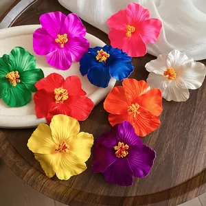 Vibrant hibiscus flower hair clips in various colors for a tropical beach vacation style