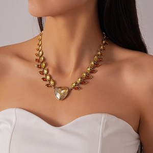 Detail of vintage gold necklace with amber rhinestones and wheat ear leaf motifs