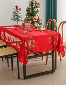 Close-up of red Christmas lace tablecloth featuring intricate hollow floral patterns