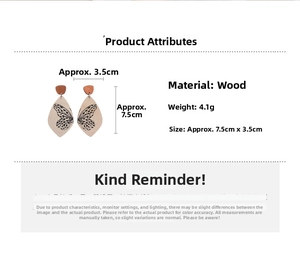 Detailed view of wood drop earrings with butterfly print and 7.5cm x 3.5cm dimensions