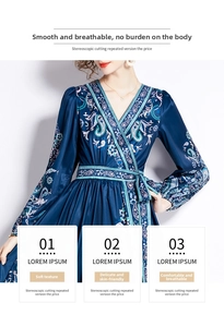 Close-up of deep blue paisley printed dress featuring a V-neckline and waist tie detail