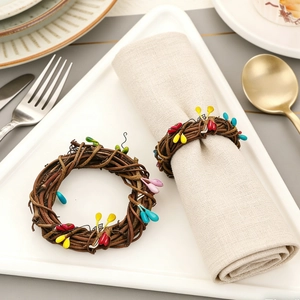 Detail of colorful woven napkin rings with leaf accents on a white plate