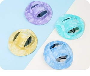 Macro detail of tie-dye pet sun hats in four colors with ear holes and adjustable toggles