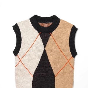 Chic argyle knit sweater vest featuring black, cream and camel patterns on white background