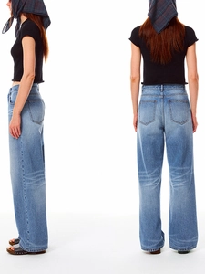 Detail view of high-waist wide-leg denim jeans in washed dark blue with back pocket design