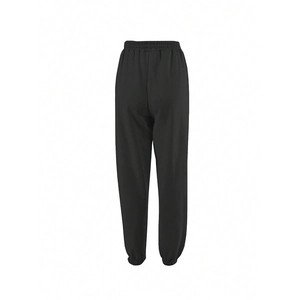 Detail view showing elastic waistband and gathered cuffs on black jogger pants back