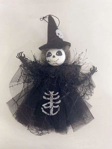 Detailed view of Halloween ghost pendant with black tulle skirt and skull face design