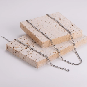 Polished silver stainless steel minimalist chain necklace on elegant stone display