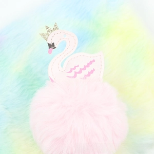 Close-up of pink swan pompom pendant with golden crown and soft plush texture detail
