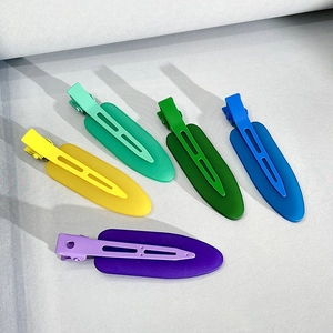 Flat lay of five matte seamless hair clips in yellow, mint, green, blue and purple