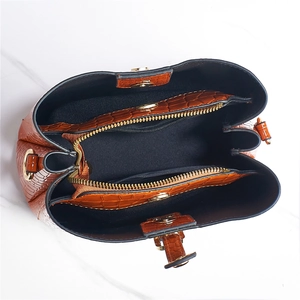 Top view of brown crocodile texture tote bag showing spacious interior with golden hardware