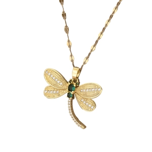 Elegant dragonfly pendant necklace in gold finish with sparkling green and white stones