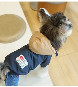 Close-up of waterproof navy pet jacket with khaki hood and durable denim pants for dogs