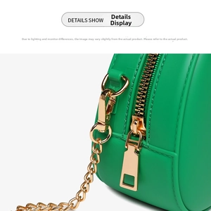 Detail view of the green jelly bag showing the side zipper and gold chain hardware