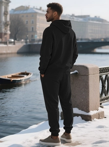 Close-up of black waffle texture knit on men's oversized hoodie and jogger sports set