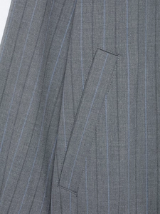 Macro shot of grey striped wool fabric detail and pocket stitching on a bomber jacket