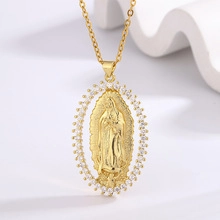 Detailed view of 18K gold Virgin Mary oval pendant with sparkling zircon embellishments