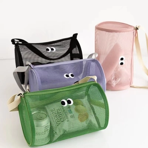 Cylindrical mesh beach bag with eye design for travel toiletries and gym use