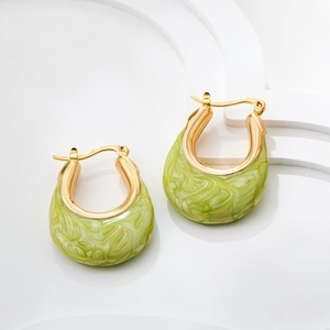 Detail of gold U-shaped hoop earrings with light green marble enamel and click-top closure