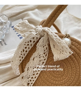 Macro detail of a brown handwoven round handbag with lace bow and pearl decoration
