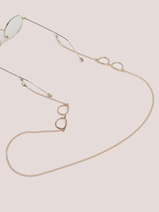 Detail of gold eyewear chain featuring mini glasses pendant and non-slip silicone loops