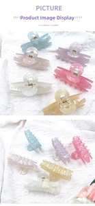 Detailed view of pastel macaron-colored acrylic hair claws with pearlescent laser finish