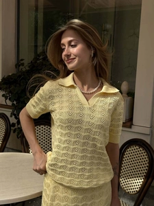 Close-up of pale yellow knit set showing intricate hollow wave pattern and texture