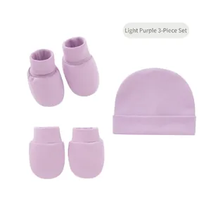 Detail shot of light purple newborn 3-piece set with knitted hat, socks and soft mittens