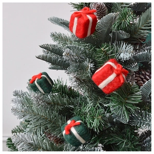 Detail of wool felt mini gift box ornament hanging on a Christmas tree branch