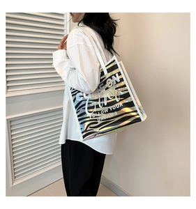 Holographic zebra print tote bag with COME ON Girl text shown on a female model
