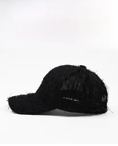 Detailed side view of black sun visor baseball cap with distressed fringe fabric texture