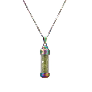 Detail view of rainbow-colored metal perfume bottle necklace with green crushed stones