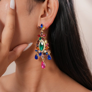 Close-up of vintage floral drop earrings with colorful rhinestones on female model