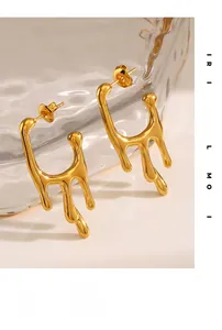 Detail of gold liquid lava drop earrings showing irregular fluid metal texture