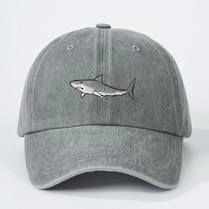 Detailed embroidery of a shark on a washed gray cotton vintage baseball cap