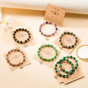 Bracciale yoga in pietra naturale con perline dorate e ciondolo a forma di occhio greco