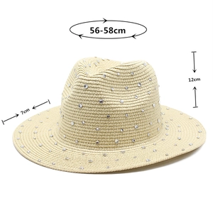 Detailed view of straw Panama hat with sparkling rhinestones and dimension markings