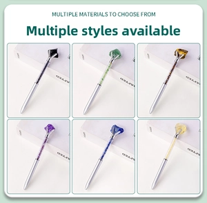 Detail view of silver metal pens filled with assorted natural crystal gemstones