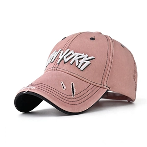 Detail of 3D NEW YORK embroidery on vintage distressed cotton baseball cap in dusty pink