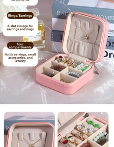 Pink leather jewelry box interior with necklace hooks and ring slots compartments