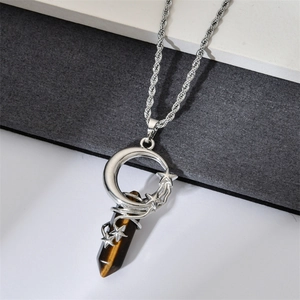 Detailed view of Tiger Eye hexagonal prism with silver moon and star wire-wrapped pendant