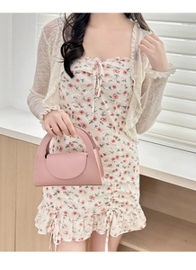 Pink leather handbag detail paired with a floral dress and beige cardigan outfit
