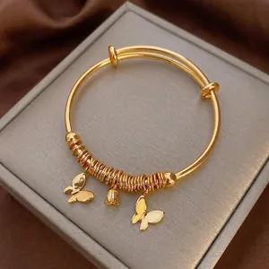 Gold plated butterfly coin bracelet with adjustable slide clasp and floral charms