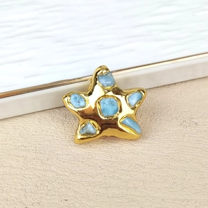 Detailed close-up of golden starfish charm with light blue natural stones for DIY jewelry