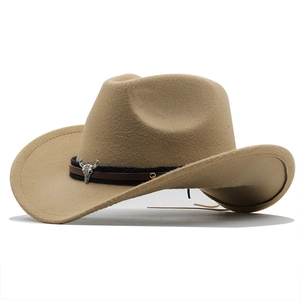 Détail de chapeau de cowboy avec emblème de tête de taureau argentée et ruban tressé