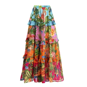 Detail of multi-tier maxi beach skirt with vibrant tropical floral print and ruffle trims
