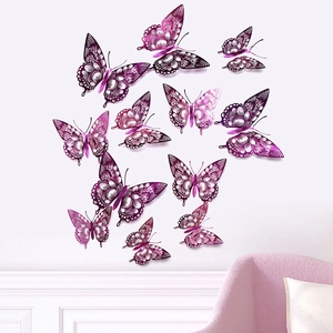 Purple hollow 3D butterfly wall stickers displayed on a white wall above a pink sofa