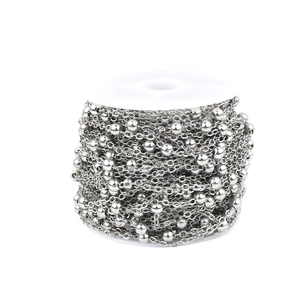 Polished silver beaded cable chain on a white spool for DIY jewelry making and crafts
