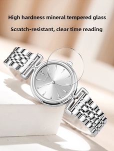 Detail of silver women's watch with scratch-resistant mineral glass and metal strap