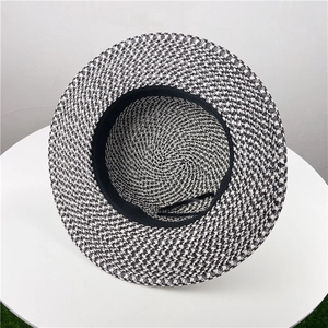 Detail of black and white woven straw hat with inner sweatband and adjustable drawstring